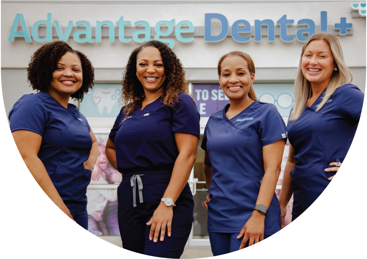 Advantage Dental employees smiling in front of a dental practice
