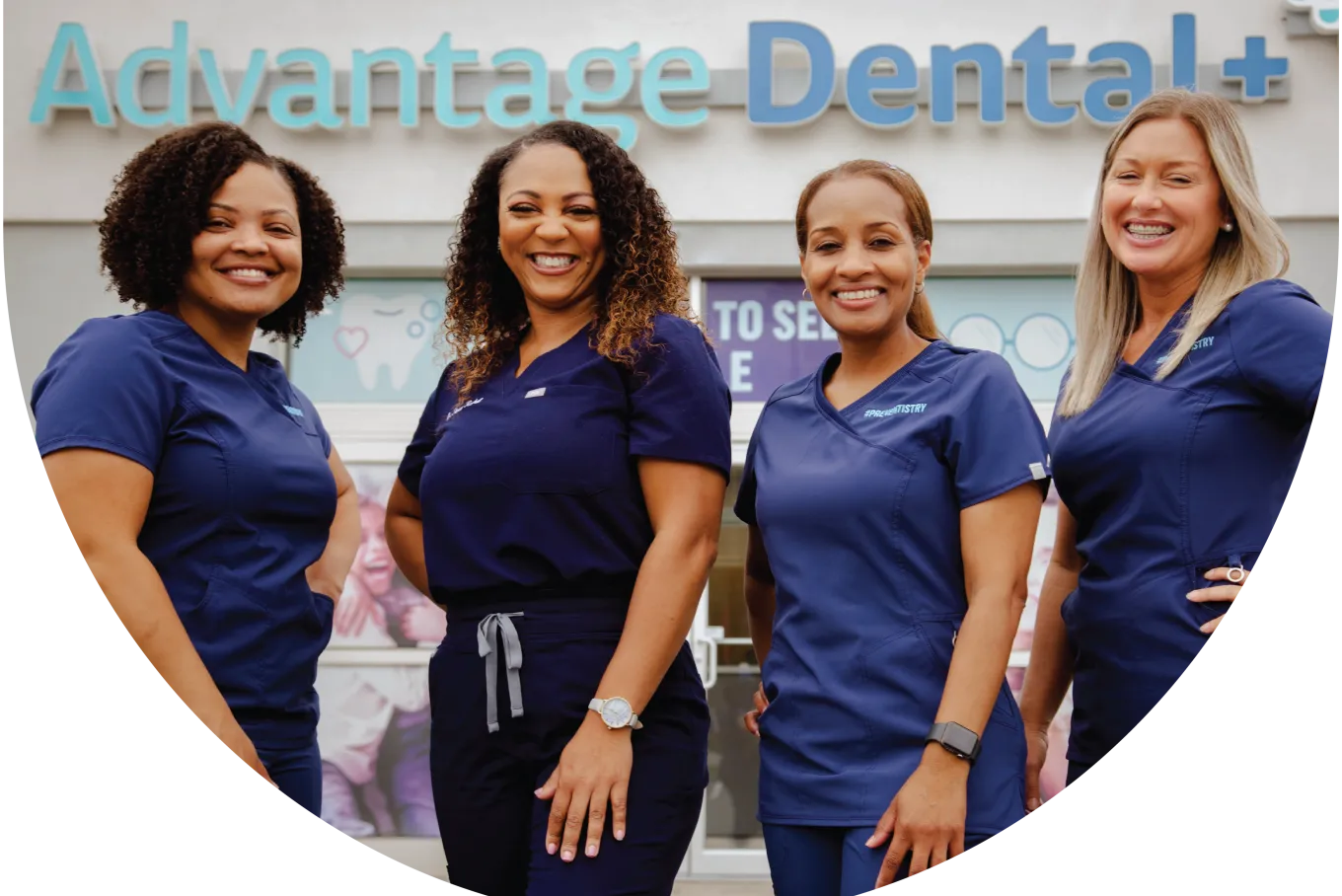 Advantage Dental employees smiling in front of a dental practice.