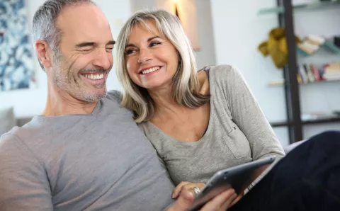 A middle-aged couple reading through health information.